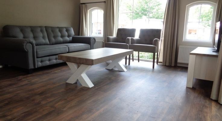 Large grey sofa, 2 armchairs, one large coffee table and TV in a contemporary style living -room in Premium range