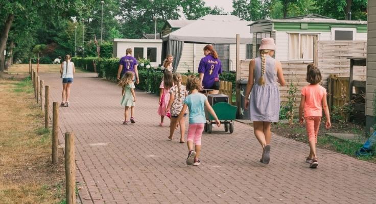 People wandering along the campsite paths